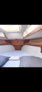 a couple of bunk beds with white sheets and pillows at chez will in Cap d'Agde