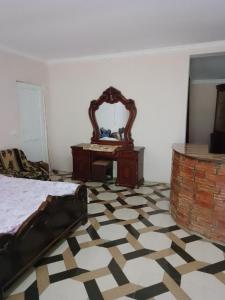 a bedroom with a bed and a mirror on the wall at House by the river in Martvili