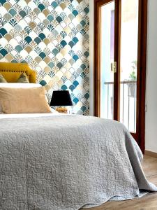 a bedroom with a bed with a patterned wall at Palazzina300 in Treviso