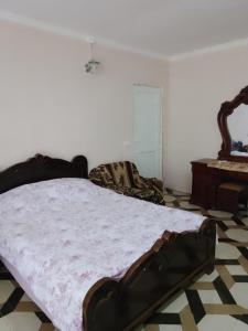 a bedroom with a bed and a table at House by the river in Martvili