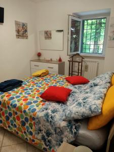 a bedroom with a bed with two pillows on it at La casa dei ricordi in Acqualagna
