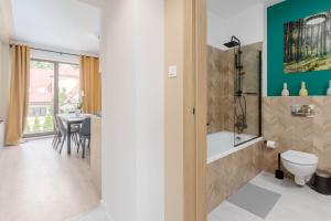a bathroom with a toilet and a dining room at Chill Apartments Warszawa Piaseczno in Józefosław +87 photos