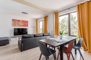 a living room with a table and a couch at Chill Apartments Warszawa Piaseczno in Józefosław