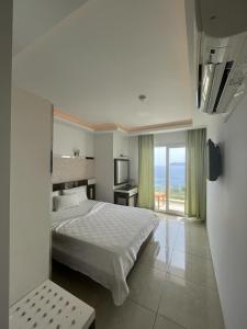 a hotel room with a bed and a large window at Kas Maki Hotel in Kaş