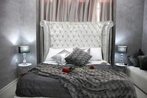 a bedroom with a large bed with red roses on it at Sliema Central Iprime Suites in Sliema