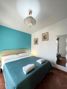 a bedroom with a bed with two pillows on it at Casa Mare e Sole IUN R2610 in Cala Gonone