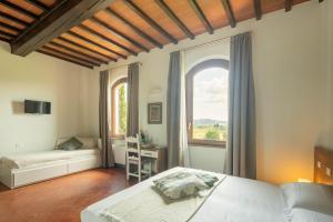 a bedroom with a bed and a window at Podere La Quercia in San Gimignano