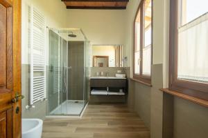 a bathroom with a glass shower and a sink at Podere La Quercia in San Gimignano