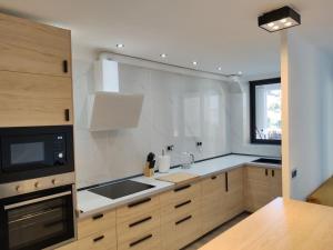 a kitchen with a sink and a stove top oven at CHARMING APARTMENT IN CALDETES in Caldes d'Estrac