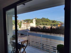 a balcony with a table and a view of a city at CHARMING APARTMENT IN CALDETES in Caldes d'Estrac