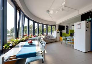 a kitchen and living room with a table and a refrigerator at Island Hostel Budapest in Budapest