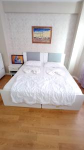1 cama blanca grande con 2 toallas en ESEN OTEL, en Antalya