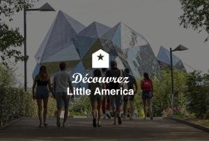 a group of people walking down a sidewalk with the text december little america at Little America - Appart Hôtel 3km Futuroscope in Jaunay-Clan