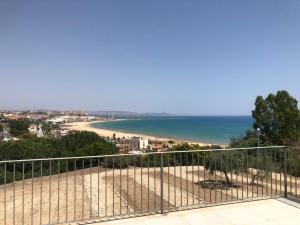 a view of a beach from a balcony at Villa Martorana, Camere e Appartamenti Short Let's in Porto Empedocle
