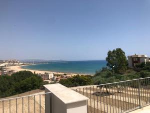 a balcony with a view of a beach and the ocean at Villa Martorana, Camere e Appartamenti Short Let's in Porto Empedocle