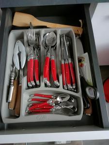 a tray with utensils in a drawer at Studio Laly in Le Tréport +9 photos