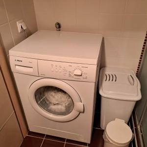a laundry room with a washing machine and a toilet at Apartment beside the sea in Hanioti