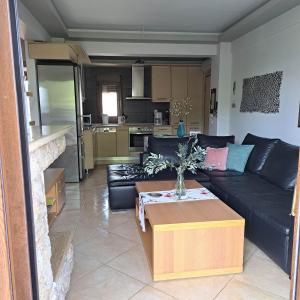 a living room with a couch and a table at Apartment beside the sea in Hanioti