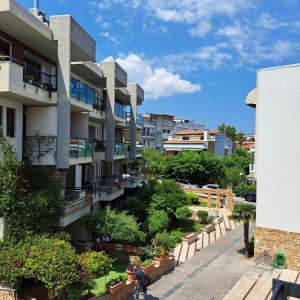 an apartment building with a garden in a city at Apartment beside the sea in Hanioti