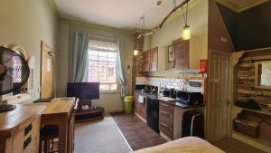 a kitchen with a desk and a counter top at The Alder Studio @ The Pheasant in Telford