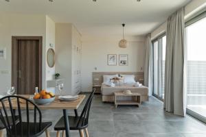 a living room with a bed and a table and chairs at Oliva Verde in Galatás