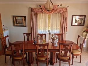 a dining room with a wooden table and chairs at Serra e Mar Ferragudo in Ferragudo