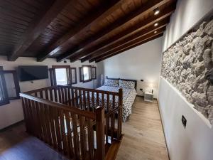 a bedroom with a bed and a stone wall at Il Vicoletto in Marostica