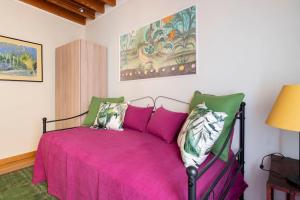 a bedroom with a pink bed with pillows at Diladdarno-Florence style APT in Florence