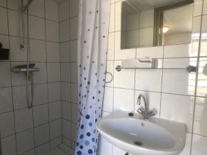 a bathroom with a sink and a shower at Egelantierlaan 21a in Cadzand +11 photos