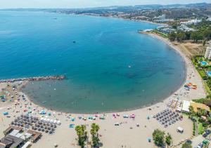 an aerial view of a beach with people and umbrellas at Spacious Beachfront Town House in Estepona with Fully Equipped Kitchen, Pools, Garden, Sea View in Estepona