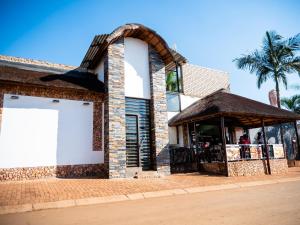 a building with a large white door on the side of it at Royal Lodge in Sibasa