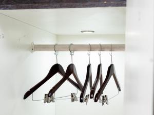 a row of shoes hanging from a rack in a closet at Royal Lodge in Sibasa