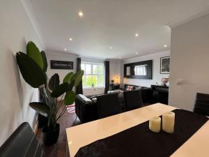 a living room with a table and chairs and a couch at Three Bed Townhouse with Parking in Telford
