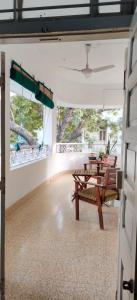 a dining room with a table and a bench at Srinekatan Heritage Villa Homestay in Ahmedabad