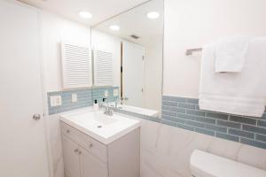 a white bathroom with a sink and a mirror at Sundown Studio 3268 in Wesley Chapel +44 photos