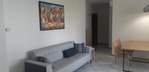 a living room with a couch and a painting on the wall at Easy Gardalake in Riva del Garda