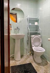 a bathroom with a toilet and a sink and a mirror at View Corner in Tbilisi City