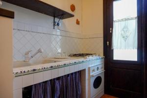 a kitchen with a sink and a stove at Dal Canonico in Mola di Bari