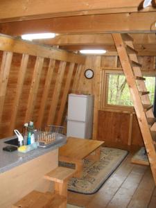 a kitchen with a counter and a refrigerator in a cabin at Niseko Shirokuma Cottage in Niseko