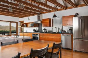a kitchen with a wooden table and a dining room at Wild Run River House in Nehalem +29 photos
