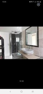 a bathroom with a sink and a shower and a mirror at Room for rent in Roma Conca d'oro near subway line b in Rome