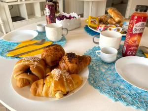 a table with a plate of pastries on a table at Luna Nuova Suites in Naples