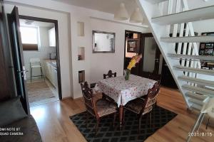 a dining room with a table and a staircase at Family house by the Sziget festival in Budapest