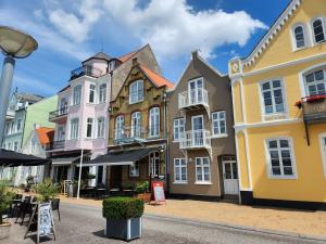 a row of colorful buildings on a street at Sunset Penthouse in Sønderborg