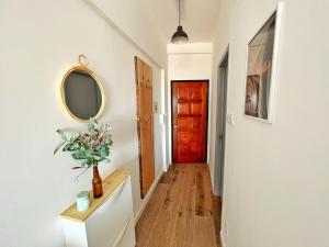 a hallway with a red door and a mirror at ROOM 335 in São Martinho do Porto +21 photos