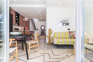 a living room and dining room with a yellow couch at Casa Alegra in Carvalhal