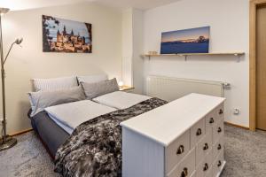 a bedroom with a bed and a couch in it at Apartment Casa Gina in Stockach