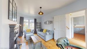a living room with a couch and a table at Bunkers Hill Cottage in Tackley