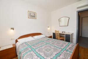 a bedroom with a bed and a desk and a desk at Miro Apartment in Rovinj