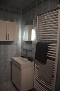 a bathroom with a sink and a mirror and a towel at maison de bourg en pierre in Saint-Maurice